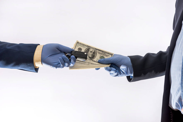 car sales in quarantine conditions coronavirus hands holding car key  and dollar bills isolated. Buying car concept - Foto, Imagen