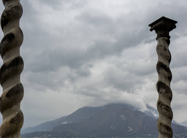Italy, Varenna, Lake Como, a pillar overlooking a mountain - Photo, Image