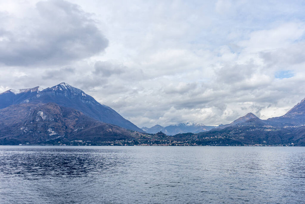 ヨーロッパ、イタリア、バレンナ、コモ湖、背景に山のある水の大規模な体 - 写真・画像