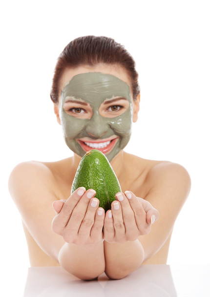 Spa woman in facial mask and avocado - Fotoğraf, Görsel