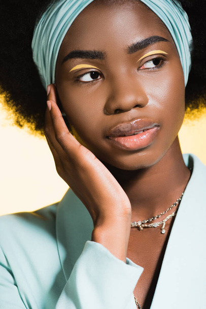 african american young woman in blue stylish outfit isolated on yellow  - Фото, зображення