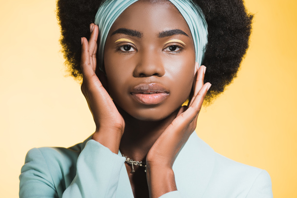 african american young woman in blue stylish outfit isolated on yellow  - Фото, изображение