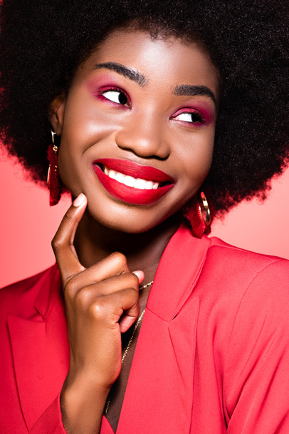 happy african american young woman in stylish outfit isolated on red - Zdjęcie, obraz