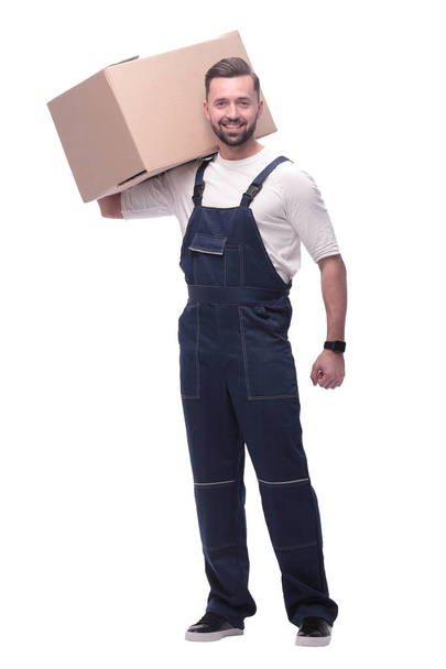 in full growth. a man in overalls with a box on his shoulder - Fotografie, Obrázek