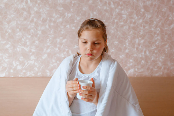 close up girl covered in blanket drinking tea - Photo, Image