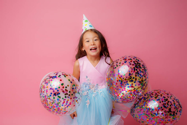 birthday girl posing with balloons against pink - Photo, Image