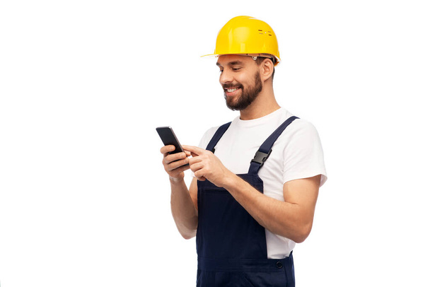 happy male worker or builder with smartphone - Фото, изображение