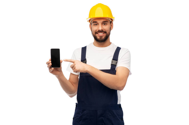 happy male worker or builder showing smartphone - Foto, Imagem