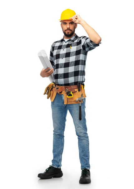 male worker or builder in helmet with blueprint - Foto, imagen