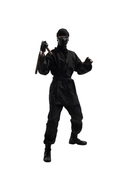 one japanese ninja in black uniform with nunchuks cold weapon, on white background, isolated - Φωτογραφία, εικόνα