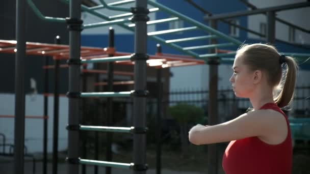 fit sportovní kavkazský hezká dívka cvičení ve sportovním oblečení venku na sportovním hřišti - Záběry, video