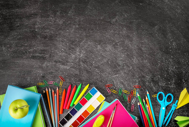 School supplies on blackboard background Top view. Copy space. Back to school concept. - Photo, Image