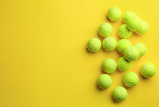 Tennis balls on yellow background, flat lay. Space for text - Photo, Image