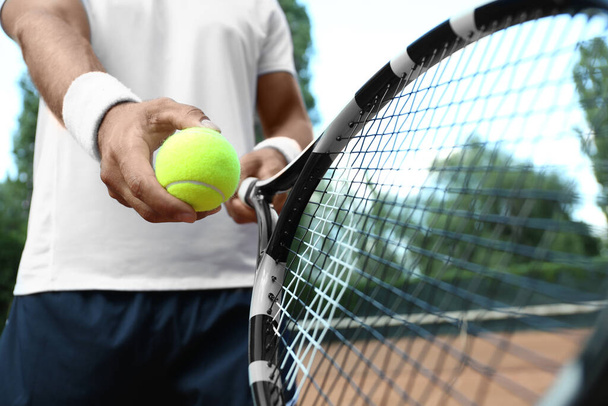 Sportsman preparing to serve tennis ball at court, closeup - Fotoğraf, Görsel