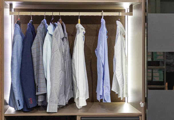 Business Shirts and Suits at Hangers in Wardrobe Closet - Valokuva, kuva