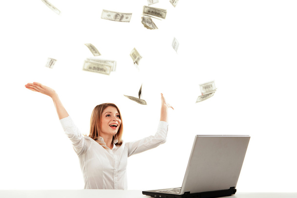 Young woman with laptop and flying money. Isolated - Photo, Image
