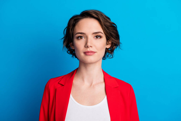 Close-up portrait of attractive corporate content brown-haired businesslady wear red blazer isolated on bright blue color background - Фото, изображение