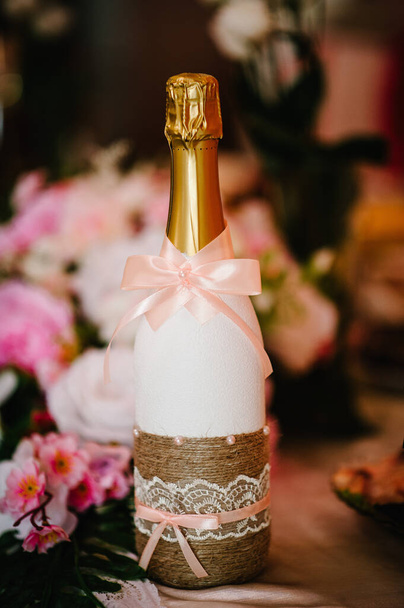 Bottle of champagne bride and groom on the festive table newlyweds. happy Wedding day. - Photo, Image