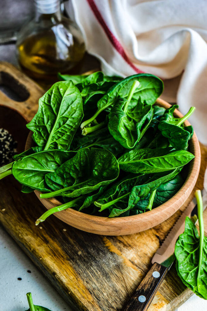Organic food concept with fresh baby spinach leaves for healthy salad cooking - Photo, Image
