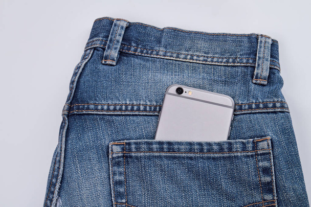 Pants with smartphone in a pocket. - Foto, Imagen