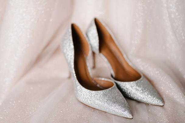 Stylish silver shoes, are isolated standing on white background. Wedding accessory bride. - Foto, Imagem