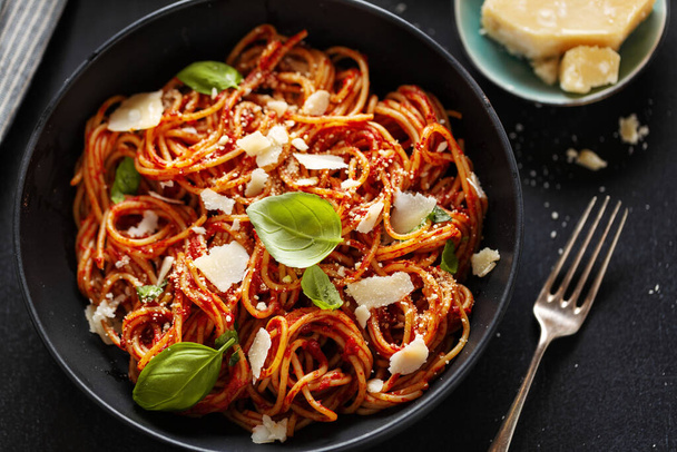 Spaghetti pasta with tomato sauce cheese and basil served in bowl.  - Photo, image