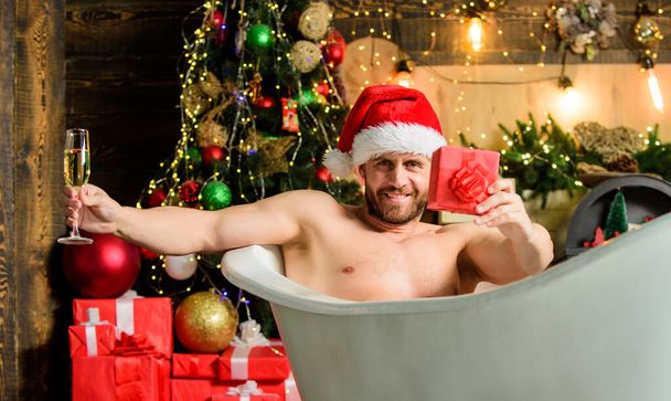 Confident and sexy. xmas present. christmas spa. happy new year gift. erotic wish. feel desire. macho drink champagne after party. sexy mature man bath. winter holidays. muscular man relax bathtub - Zdjęcie, obraz