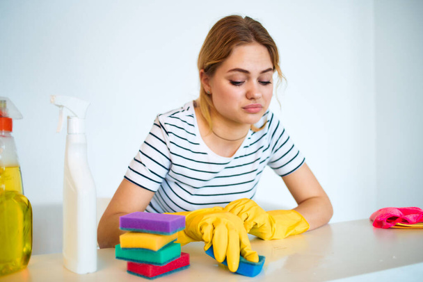 Woman at the table washing supplies housework hygiene service - Photo, Image