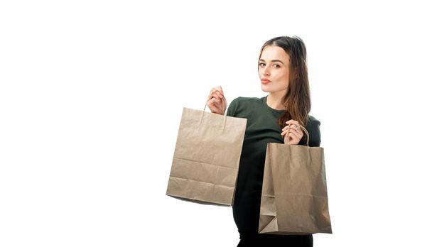 Woman is holding two grocery shopping bags on white background. Isolated background. - Photo, Image