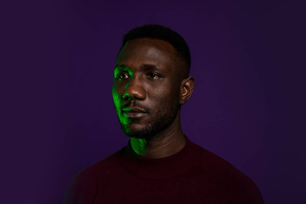 Handsome black man looking away with blank facial expression. Portrait. Isolated background. Head shot.  - Photo, Image