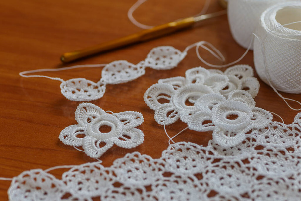 Crochet knitting. Lace of flowers.  Handmade Irish lace as a background - Foto, Bild