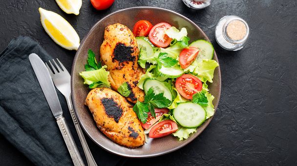 Grilled chicken breast. Fried chicken fillet and fresh vegetable salad . - Photo, Image