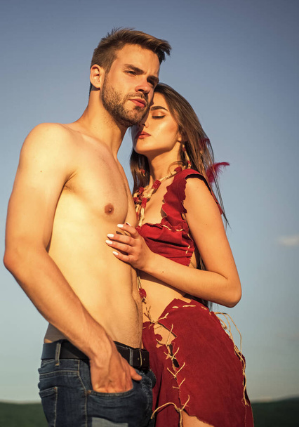 Sexy couple in love. Girl in leather clothes and fit muscular man with bare torso. Summer fest. Traditions and customs. Wild energy. Passionate couple. Wild desire. Sex games concept. Wild passion - 写真・画像