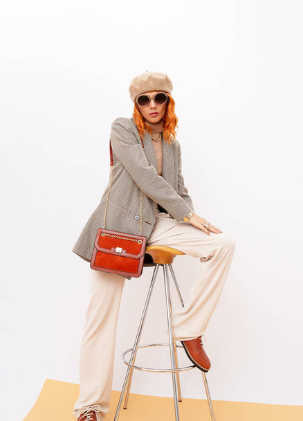 Paris Model in fashion elegant outfit. Trendy beige beret, sunglasses and stylish plaid blazer and trousers. Red velvet clutch and shoes. Style in details. Fall winter season. Vintage, retro lover - Foto, Imagem