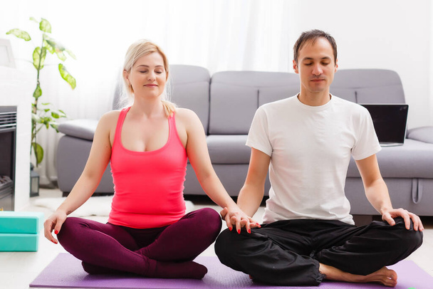 couple doing exercises at home. Yoga concept. - Photo, Image