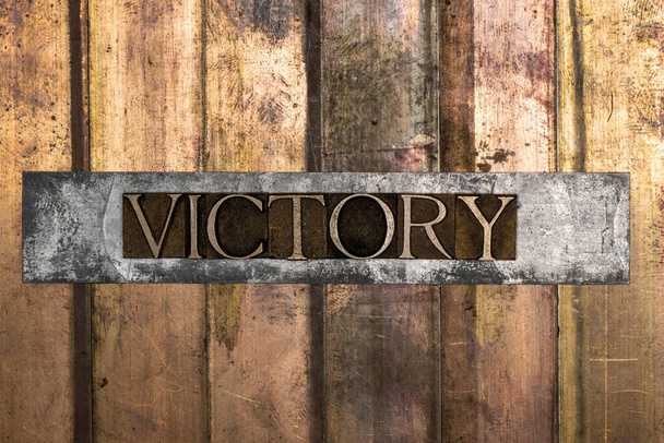 Victory text message on textured grunge copper and vintage gold background - Photo, Image