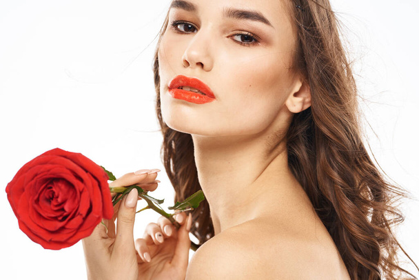 Woman with naked shoulders and red rose evening makeup light background - Photo, Image