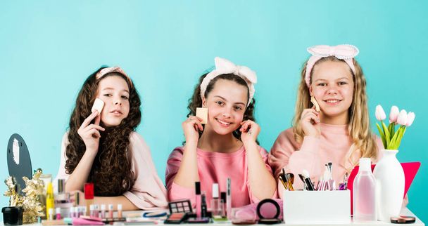 friendship party with cosmetic. relax and having fun. small girls in beauty salon. little sisters in retro fashion headscarf. makeup for kids. group of happy friends at spa. Funny advertising - Fotó, kép
