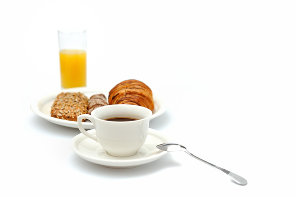 Una taza de café negro, pan de desayuno y un vaso de jugo de naranja
 - Foto, imagen