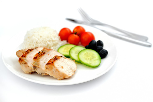 Fried chicken fillets, boiled rice and fresh vegetables - Photo, Image