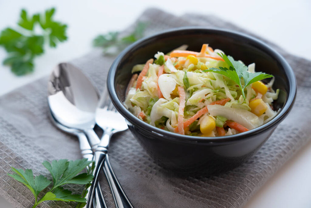 Coleslaw and Spoon and Fork. Italian parsley. Breakfast Image - Zdjęcie, obraz