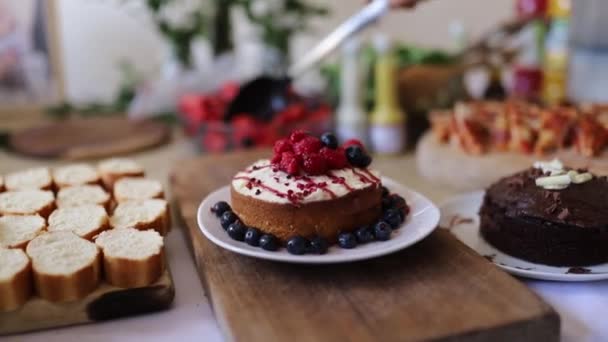 Berries and Chocolate Cakes with More Baked Goods on a Table - Felvétel, videó