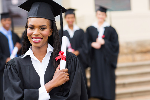 Pretty african female graduate with diploma - 写真・画像