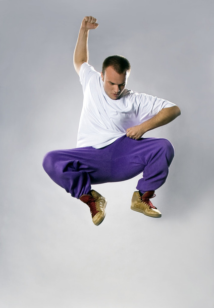 Teenager dancing breakdance in jump action - Foto, afbeelding