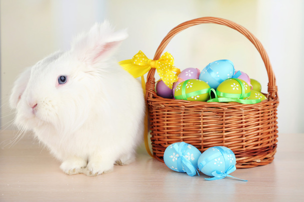 White cute rabbit and Easter eggs in basket - Foto, Imagen