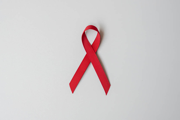 Burgundy Red Ribbon for supporting people living and illness. Healthcare and safe sex concept. December World Aids Day and multiple myeloma Cancer Awareness month - Zdjęcie, obraz