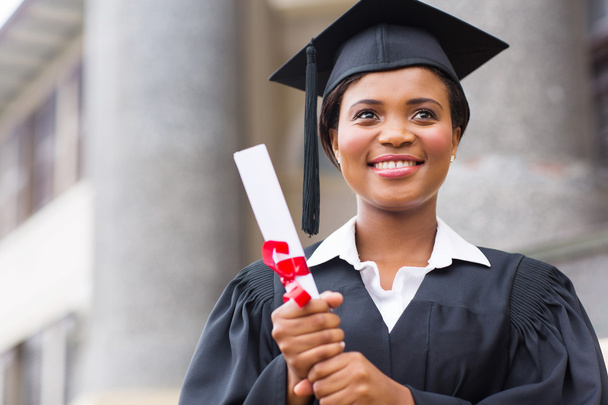 Afro american graduate holding diploma - Фото, изображение