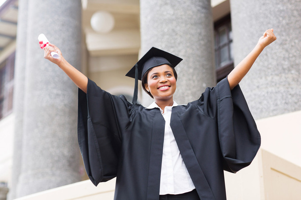 Female student with outstretched arms holding diploma - Photo, image