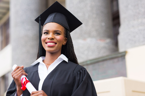 Female graduate with diploma outside college - Фото, зображення