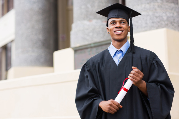 Graduate standing in front of university - Фото, зображення